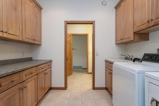 laundry room with cabinet space, visible vents, light tile patterned flooring, a sink, and independent washer and dryer