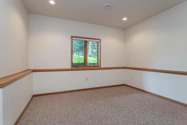 carpeted spare room featuring baseboards and recessed lighting