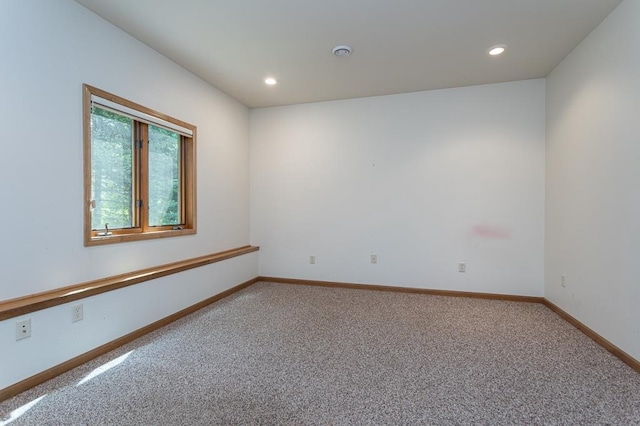 carpeted empty room with baseboards and recessed lighting