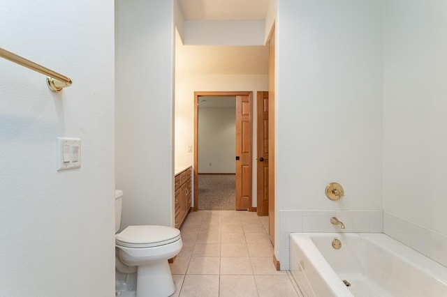 full bathroom with vanity, a garden tub, toilet, and tile patterned floors