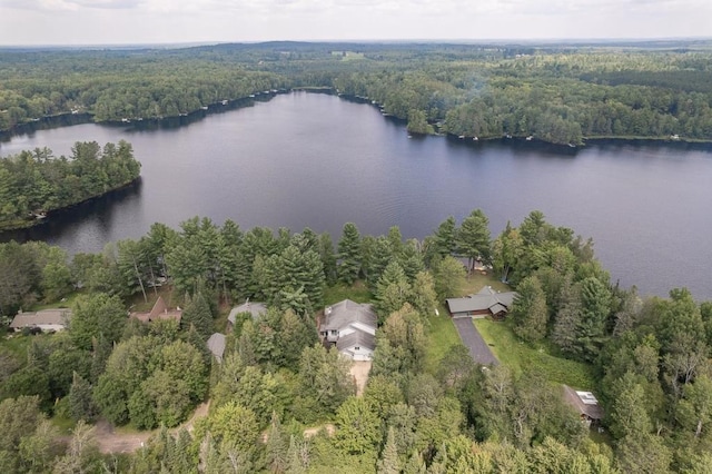 birds eye view of property featuring a water view and a wooded view