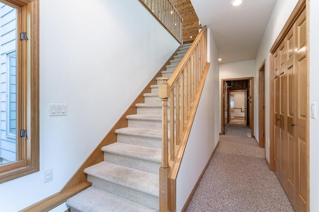 stairs with carpet floors, recessed lighting, and baseboards