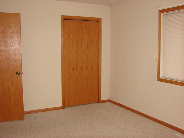 spare room with carpet floors and baseboards