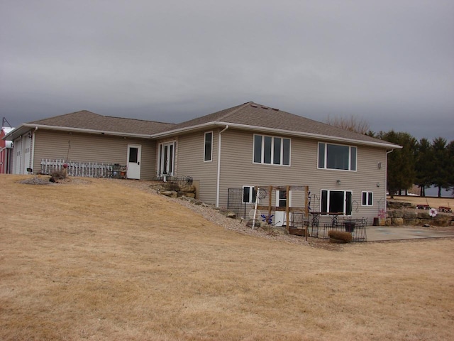 rear view of property with a patio area and a yard