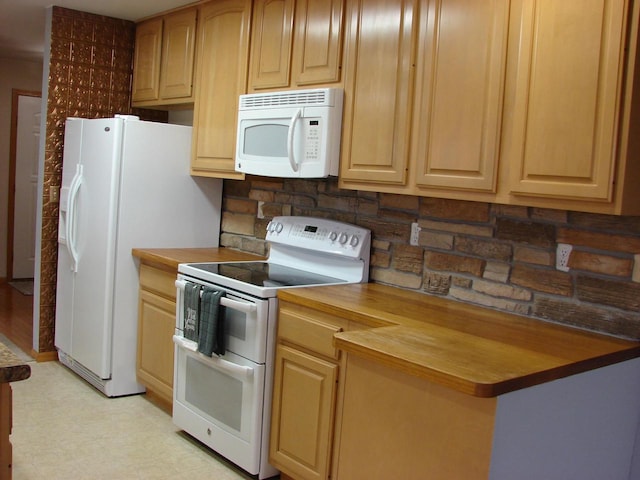 kitchen with white appliances, wood counters, light floors, and light brown cabinetry