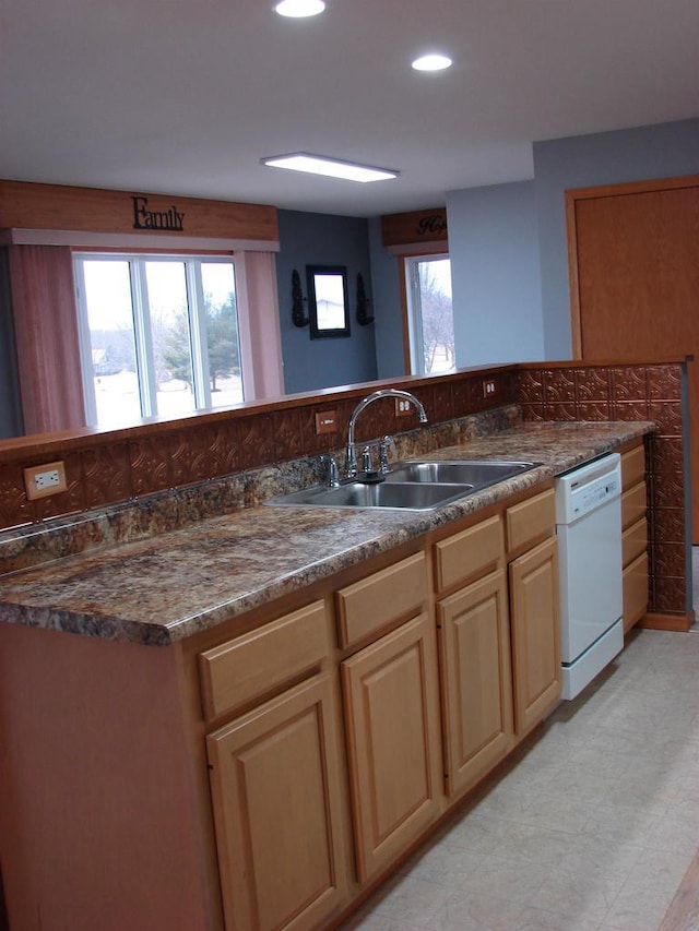 kitchen featuring a sink, light floors, dishwasher, and recessed lighting