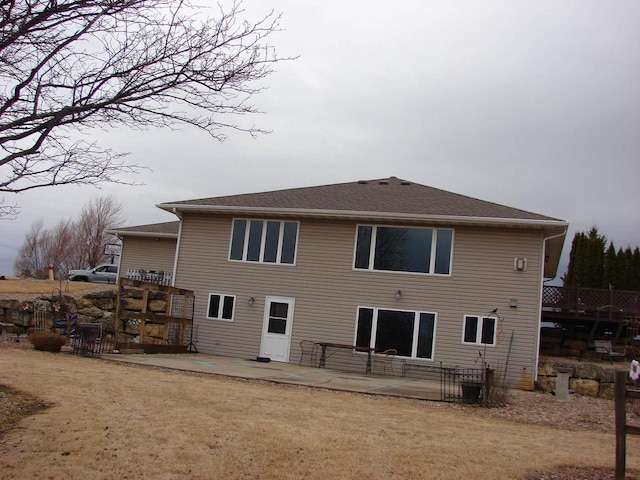 back of house with a lawn and a patio area