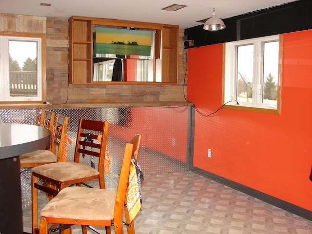 unfurnished dining area featuring tile patterned floors