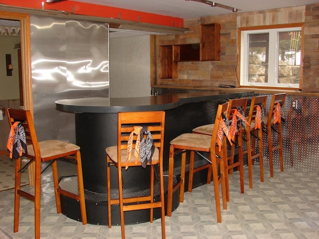 bar featuring a dry bar and tile patterned floors