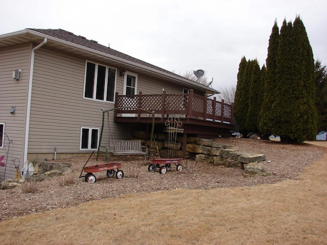 back of house featuring a wooden deck