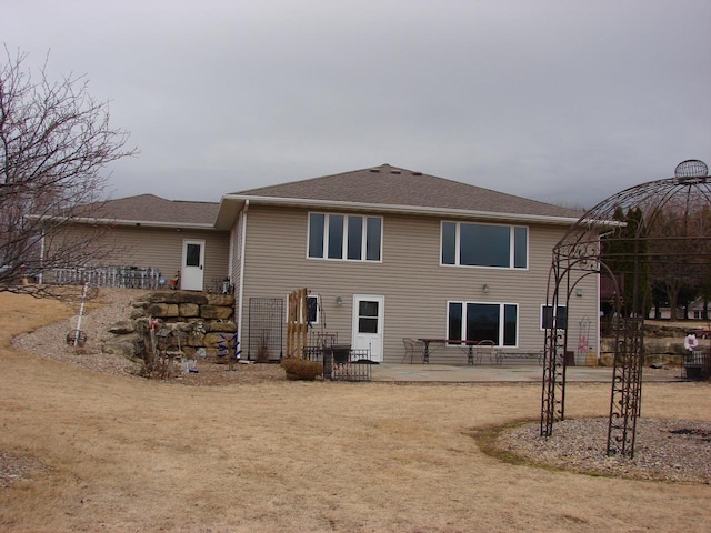 back of property with a patio