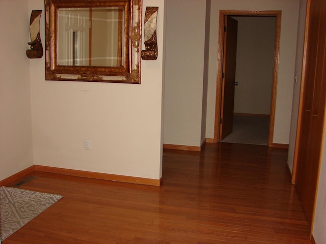 interior space featuring wood finished floors and baseboards