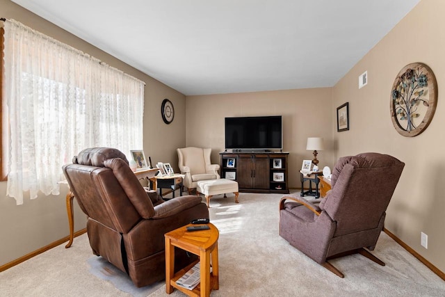 carpeted living area with baseboards