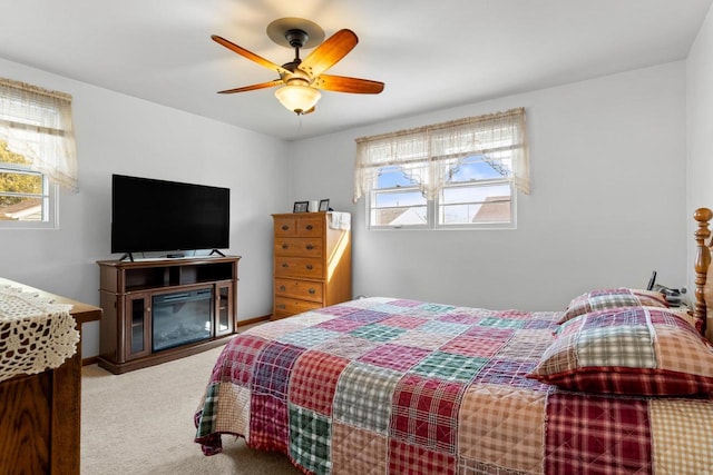 bedroom featuring multiple windows, carpet, and a ceiling fan