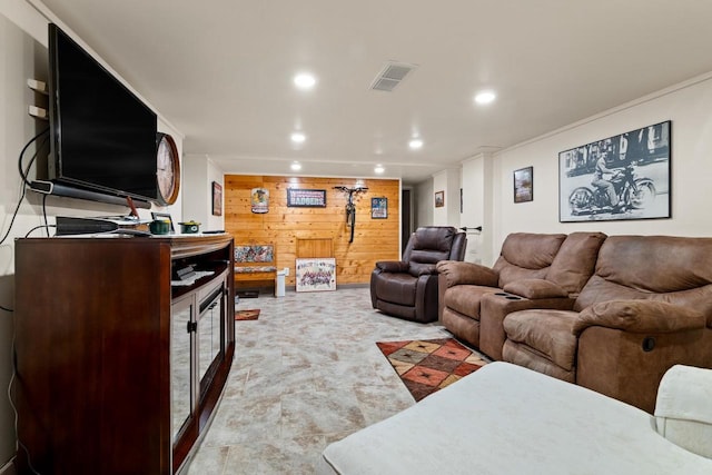 living area with wood walls, visible vents, and recessed lighting