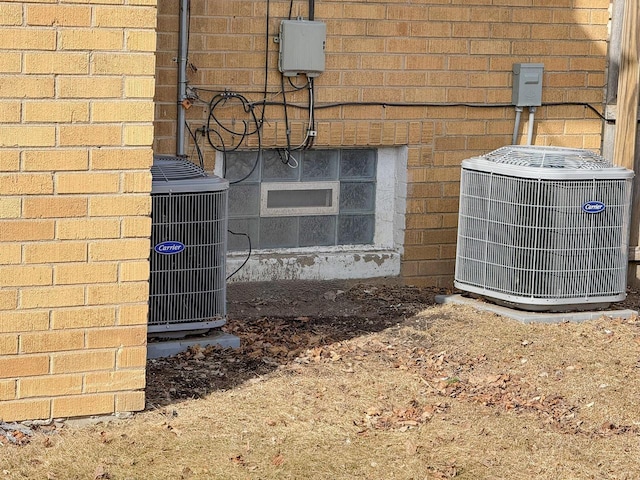 exterior details with central AC and brick siding