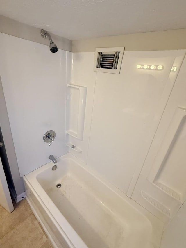 full bathroom featuring tile patterned flooring, visible vents, and shower / tub combination