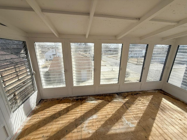 unfurnished sunroom with beam ceiling and a wealth of natural light