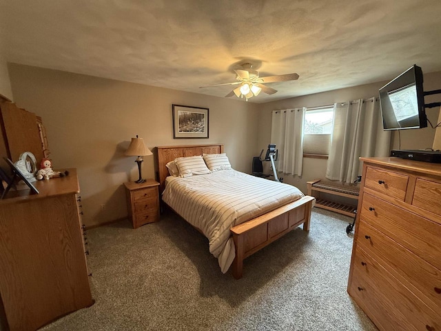 bedroom featuring carpet floors, a textured ceiling, and ceiling fan