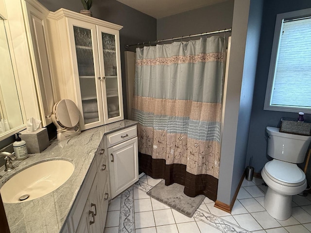 full bath featuring tile patterned flooring, a shower with shower curtain, toilet, and vanity