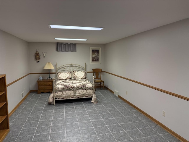 bedroom with baseboards and visible vents