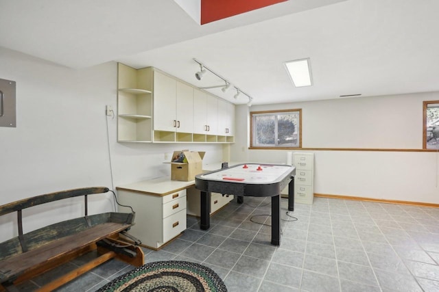 recreation room featuring tile patterned flooring and baseboards