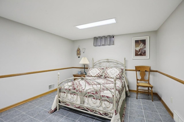 tiled bedroom with baseboards and visible vents