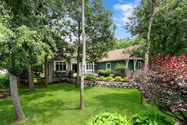 ranch-style home featuring stone siding and a front lawn