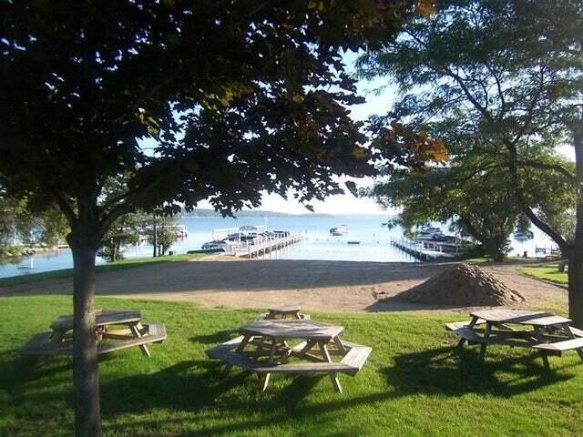 view of property's community with a lawn and a water view