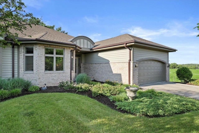 view of property exterior featuring a garage, brick siding, a shingled roof, driveway, and a lawn