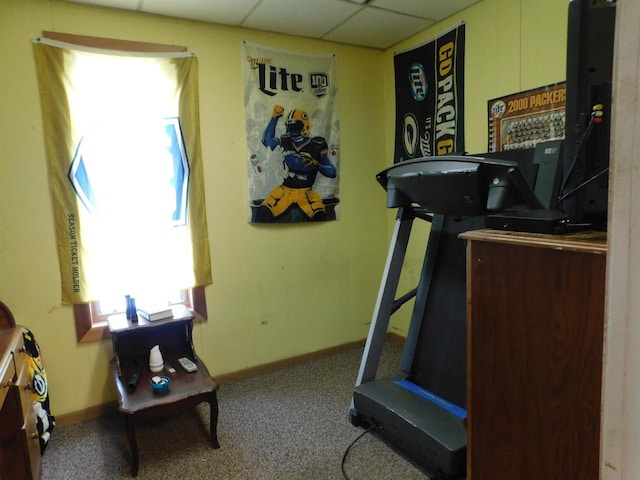 workout room with baseboards, a drop ceiling, and carpet flooring