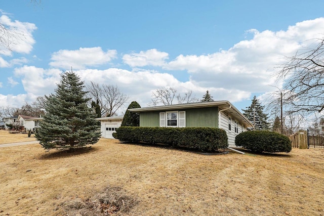 view of side of property with a yard and fence