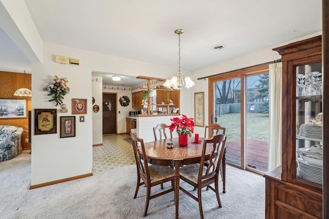 dining area with a chandelier, light colored carpet, visible vents, and baseboards