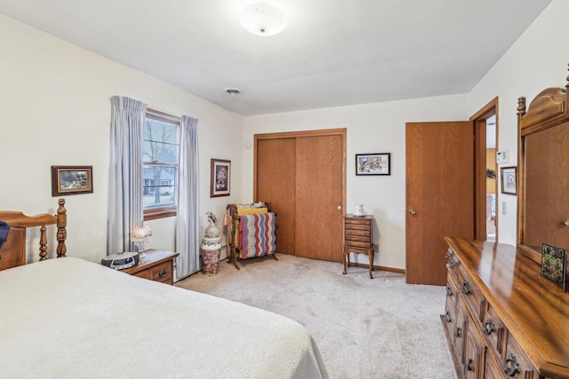 bedroom featuring light carpet, a closet, visible vents, and baseboards