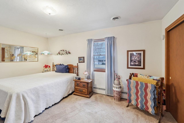 bedroom featuring light carpet, baseboard heating, and visible vents