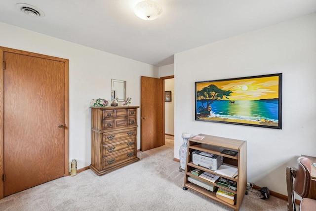 interior space featuring baseboards, visible vents, and light colored carpet