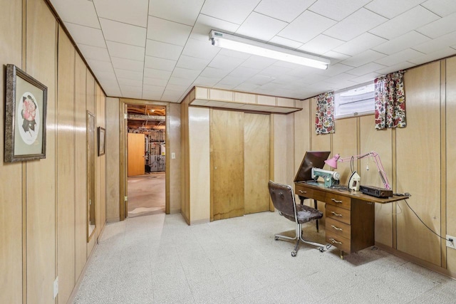 office space with light floors and wood walls