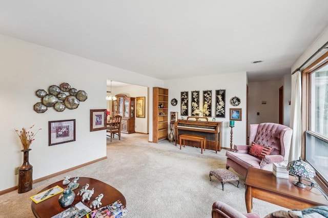 living room featuring a chandelier, carpet flooring, and baseboards