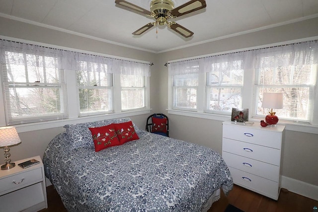 bedroom featuring dark wood-style floors, multiple windows, a ceiling fan, and crown molding