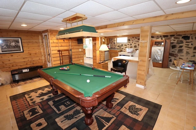 rec room with a paneled ceiling, pool table, wood walls, and tile patterned floors