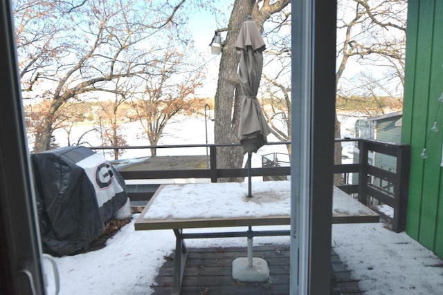 snow covered deck with grilling area