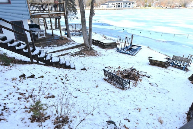 yard layered in snow featuring a garage