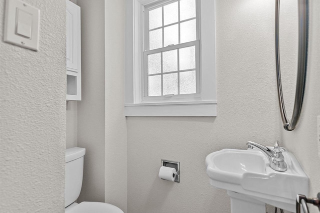 704 Fromm Ln, Elkhart Lake, WI 53020 - half bathroom featuring a sink and toilet
