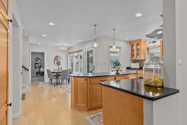704 Fromm Ln, Elkhart Lake, WI 53020 - kitchen with dark countertops, recessed lighting, glass insert cabinets, light wood-style flooring, and baseboards