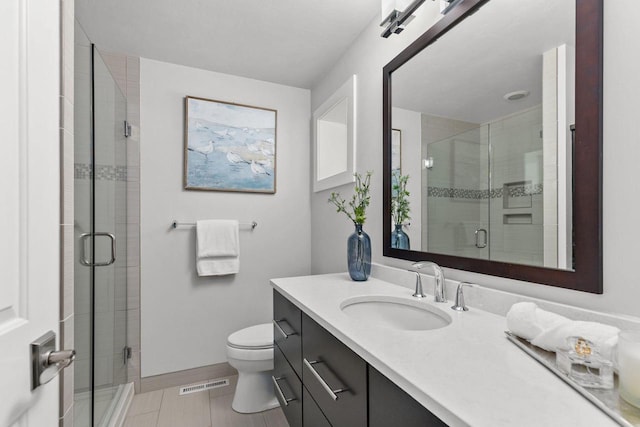 704 Fromm Ln, Elkhart Lake, WI 53020 - full bathroom with a stall shower, vanity, toilet, baseboards, and tile patterned floors