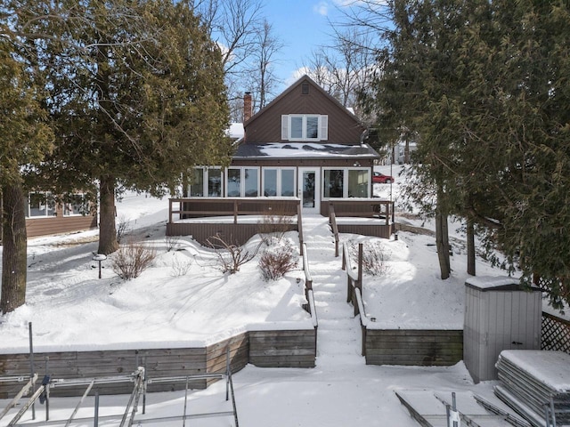704 Fromm Ln, Elkhart Lake, WI 53020 - snow covered house featuring a sunroom and a chimney