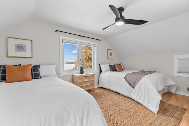 704 Fromm Ln, Elkhart Lake, WI 53020 - bedroom featuring vaulted ceiling, light wood-style floors, ceiling fan, and baseboards