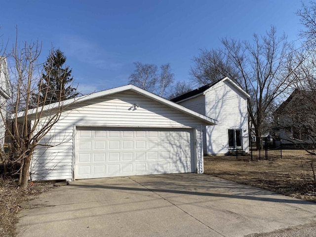 garage featuring concrete driveway