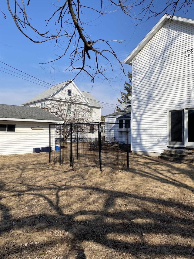 view of yard featuring entry steps and fence