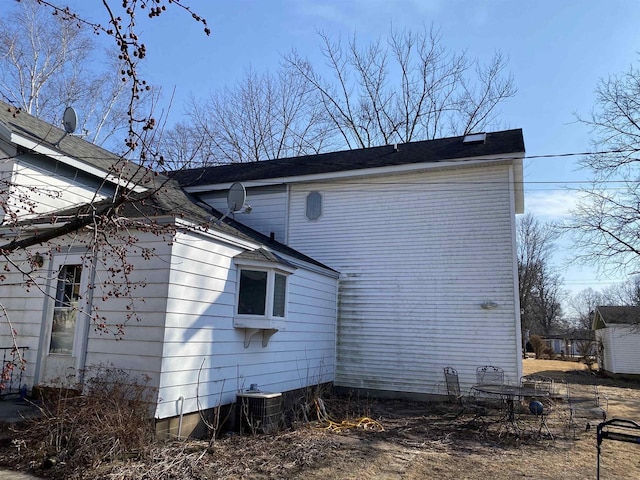 view of side of home with central air condition unit